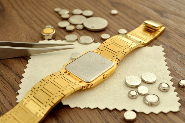 A watch next to batteries.