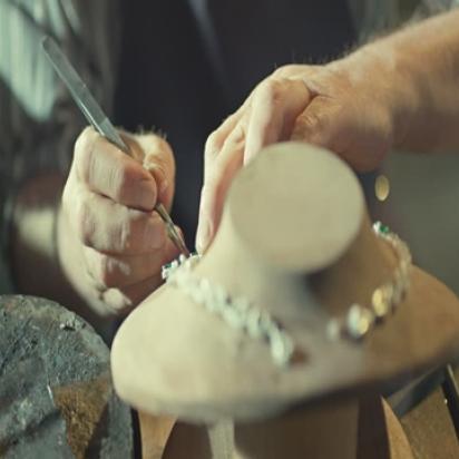 female jeweler hands repairing a pearls necklace