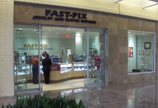 Picture of 3 smiling men receiving an award Store front of Fast-Fix store in Northpark center, in Dallas, TX